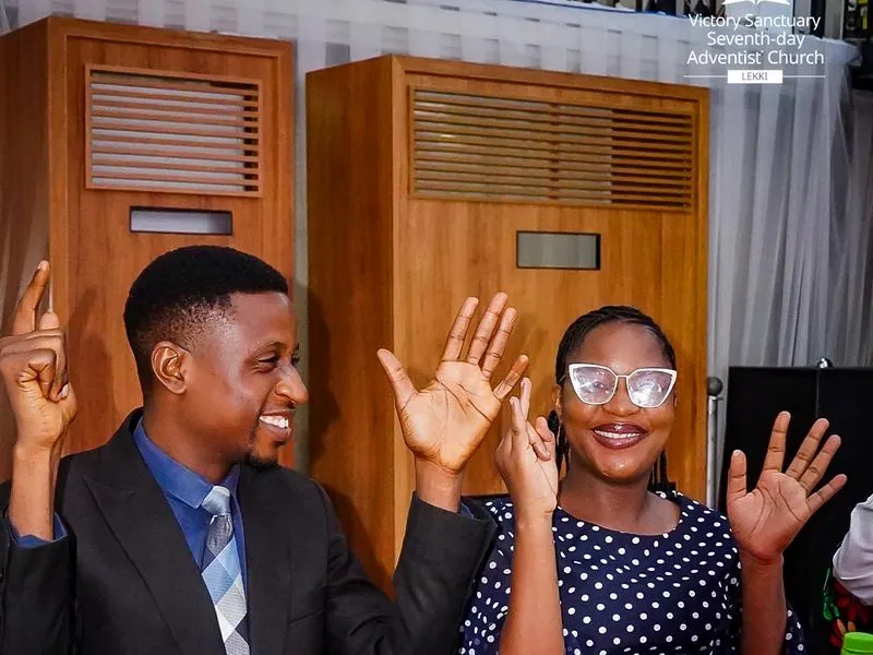 A couple raising their hands in celebration at the Couples Valentine Dinner