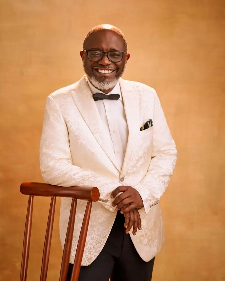 Pastor David Ajide in a cream dinner jacket, smiling