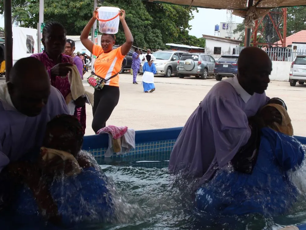 A new believer being baptised in an outdoor pool during the outreach