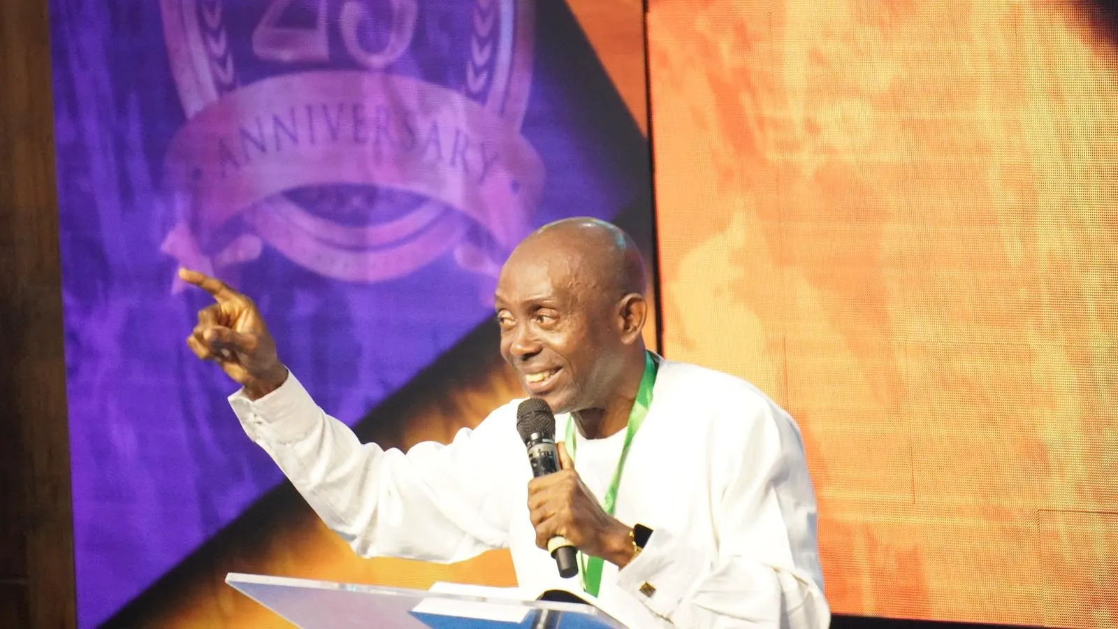 A minister preaching with joy at the Victory Believers Convention