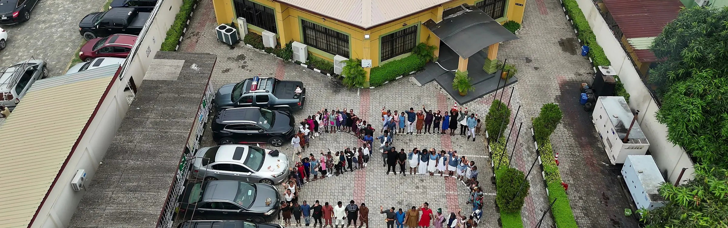 The Victory Sanctuary building in Lekki seen from above, with members standing in the shape of the number 25 in the grounds