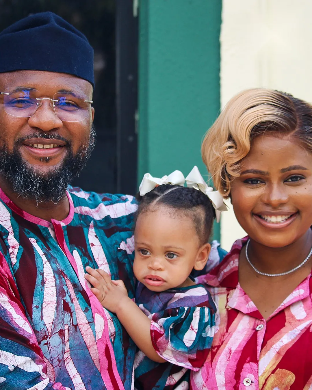 A smiling family with their baby daughter after the service
