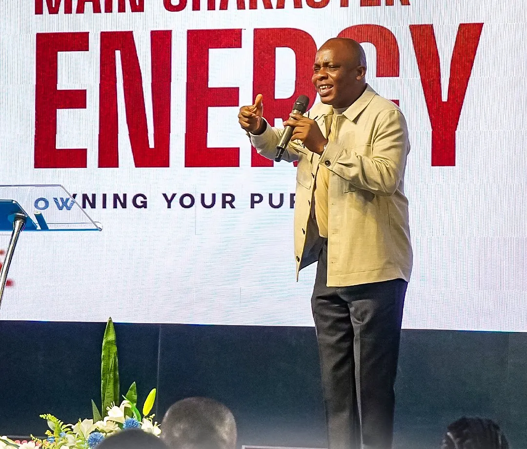 A speaker teaching from the stage with a microphone
