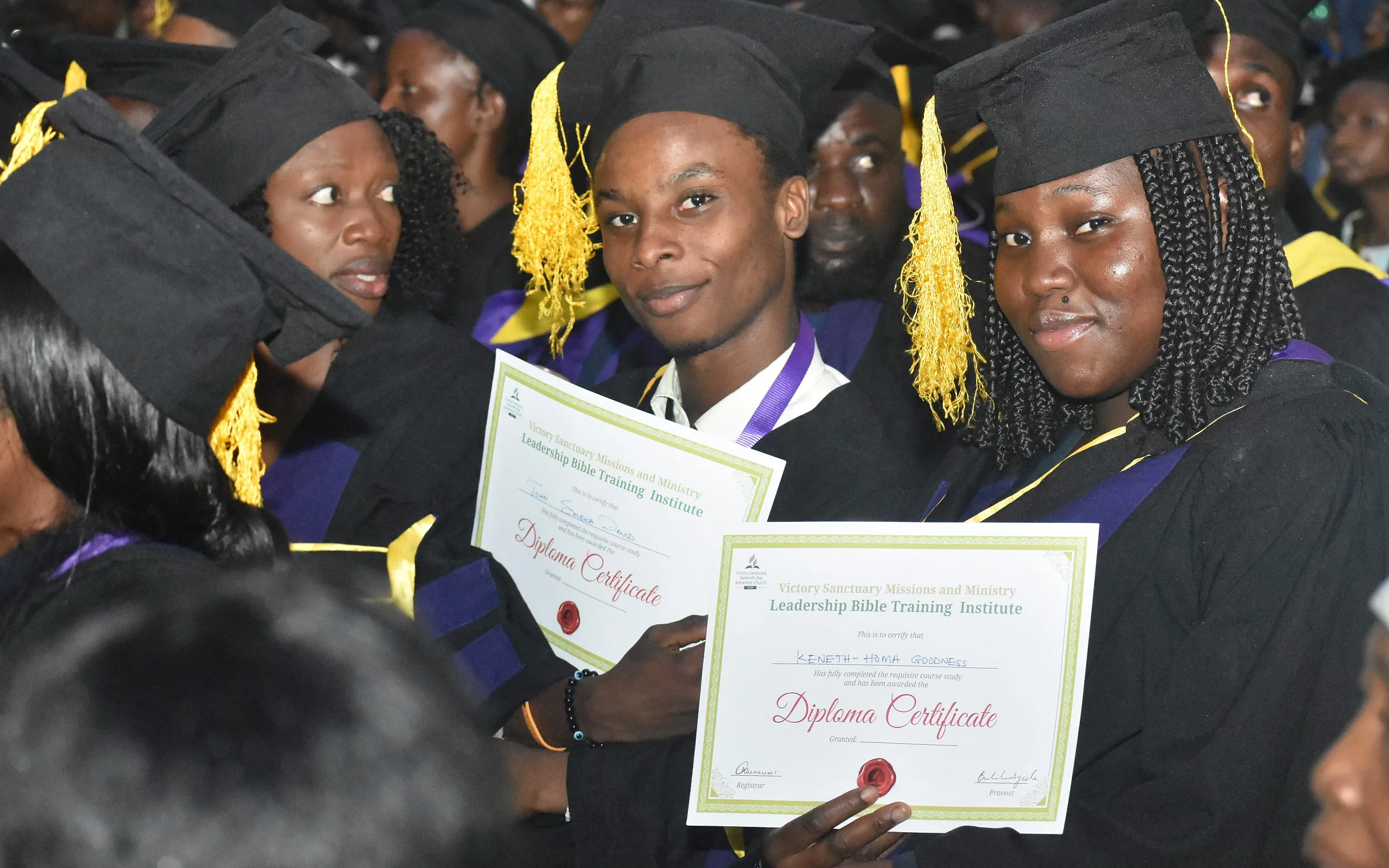 Bible school graduates smiling with their Leadership Bible Training Institute diplomas
