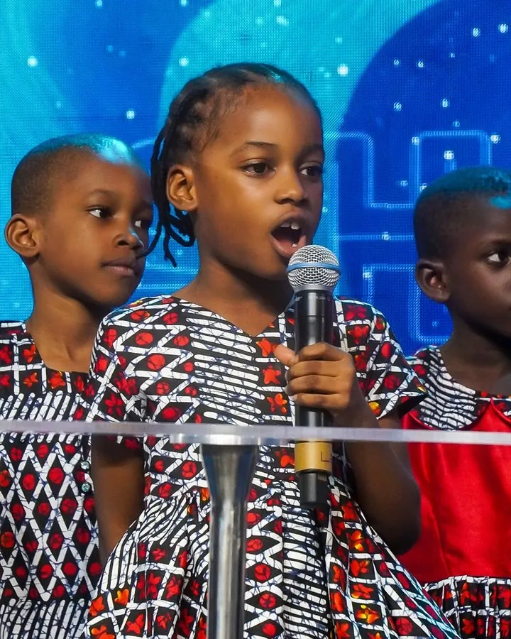 Two girls singing into a microphone at Children’s Sabbath