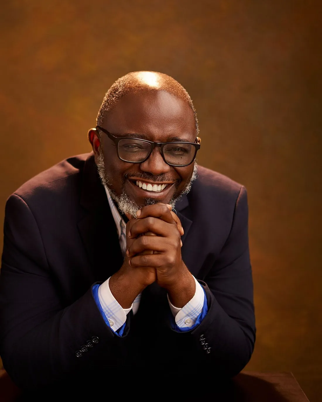 Pastor Bukky Ajide smiling in a navy suit