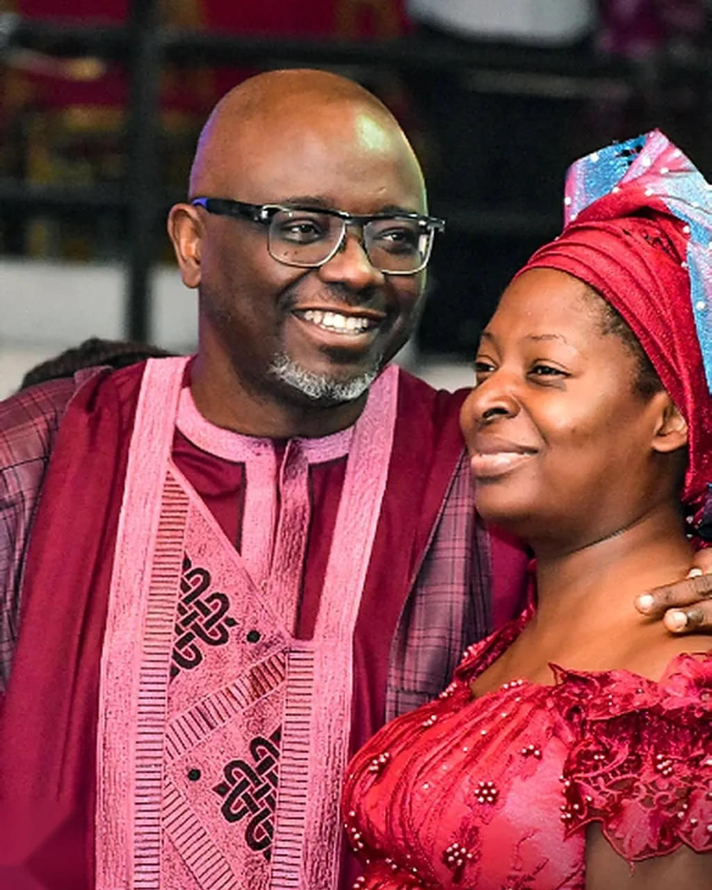 Pastor Bukky Ajide smiling with his arm around Pastor Bola Ajide, both dressed in red