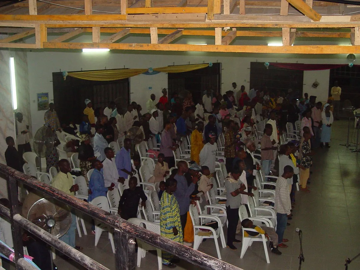 Worship beneath the unfinished timber roof in 2004
