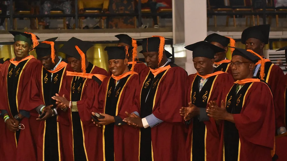 Leadership Training Institute graduates in red robes celebrating at their graduation