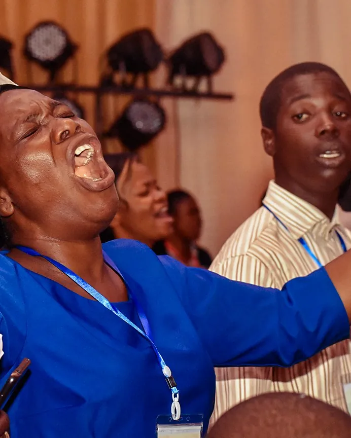 A woman crying out in worship with her arms stretched out