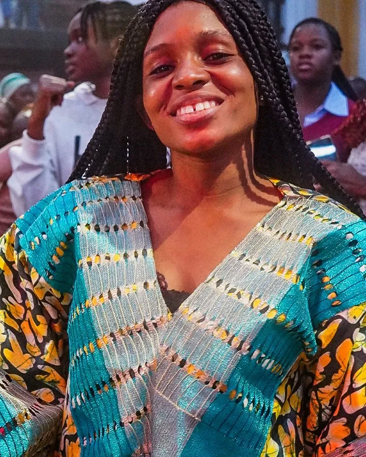 A young woman in a colourful dress smiling at VBC 2026