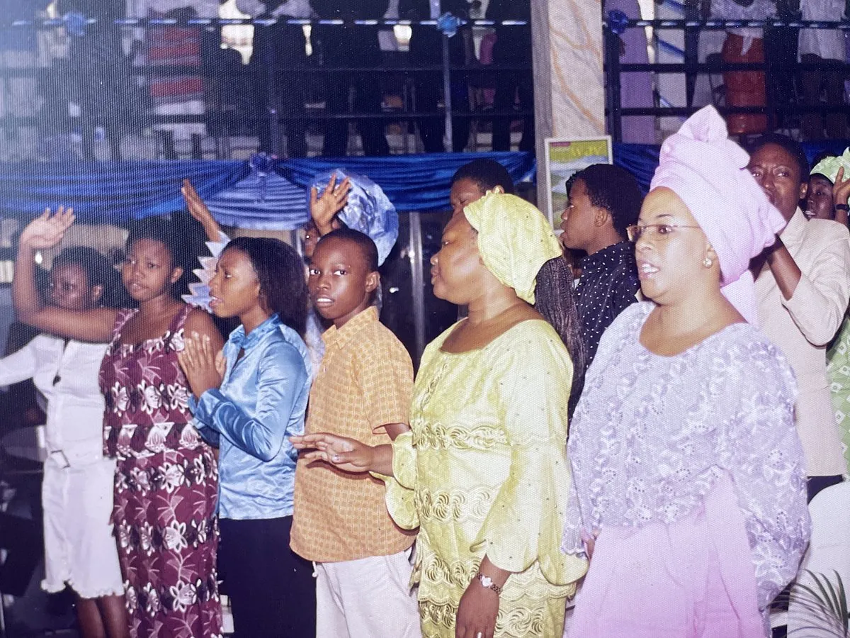 Members standing in praise with their hands raised