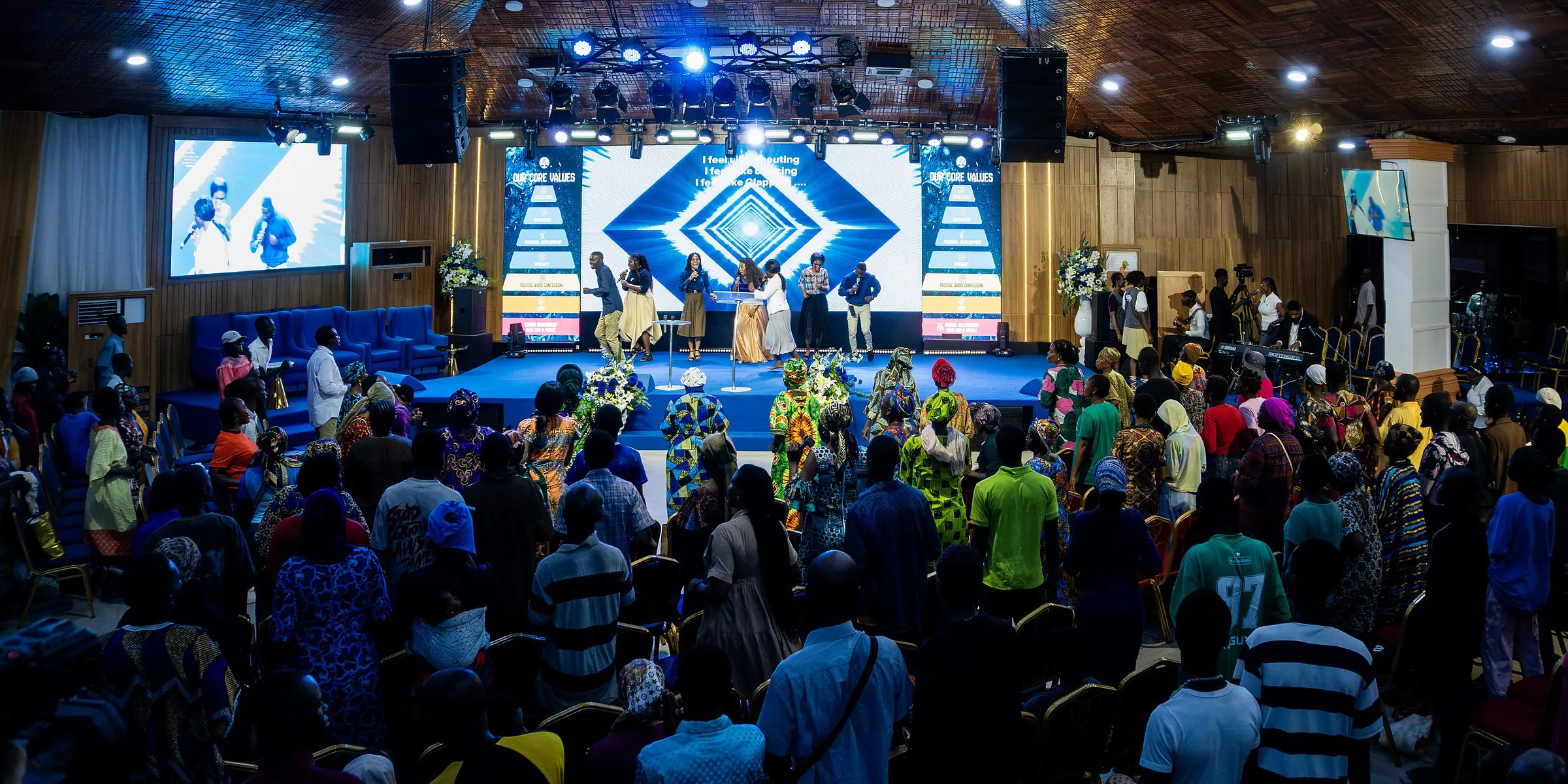 The congregation standing in worship before the stage in the Lekki sanctuary